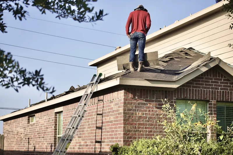 Professional roofer working on a residential roof in Timberland Heights